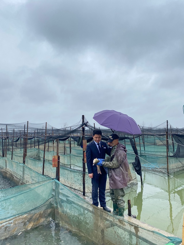 6r余干支行金融為民服務(wù)隊(duì)黨員正在吳師傅的魚(yú)塘查看養(yǎng)殖情況.jpg